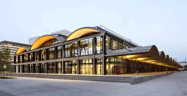 The Station F building in Paris, its glass facade under the concrete vaults of the Halle Freyssinet.